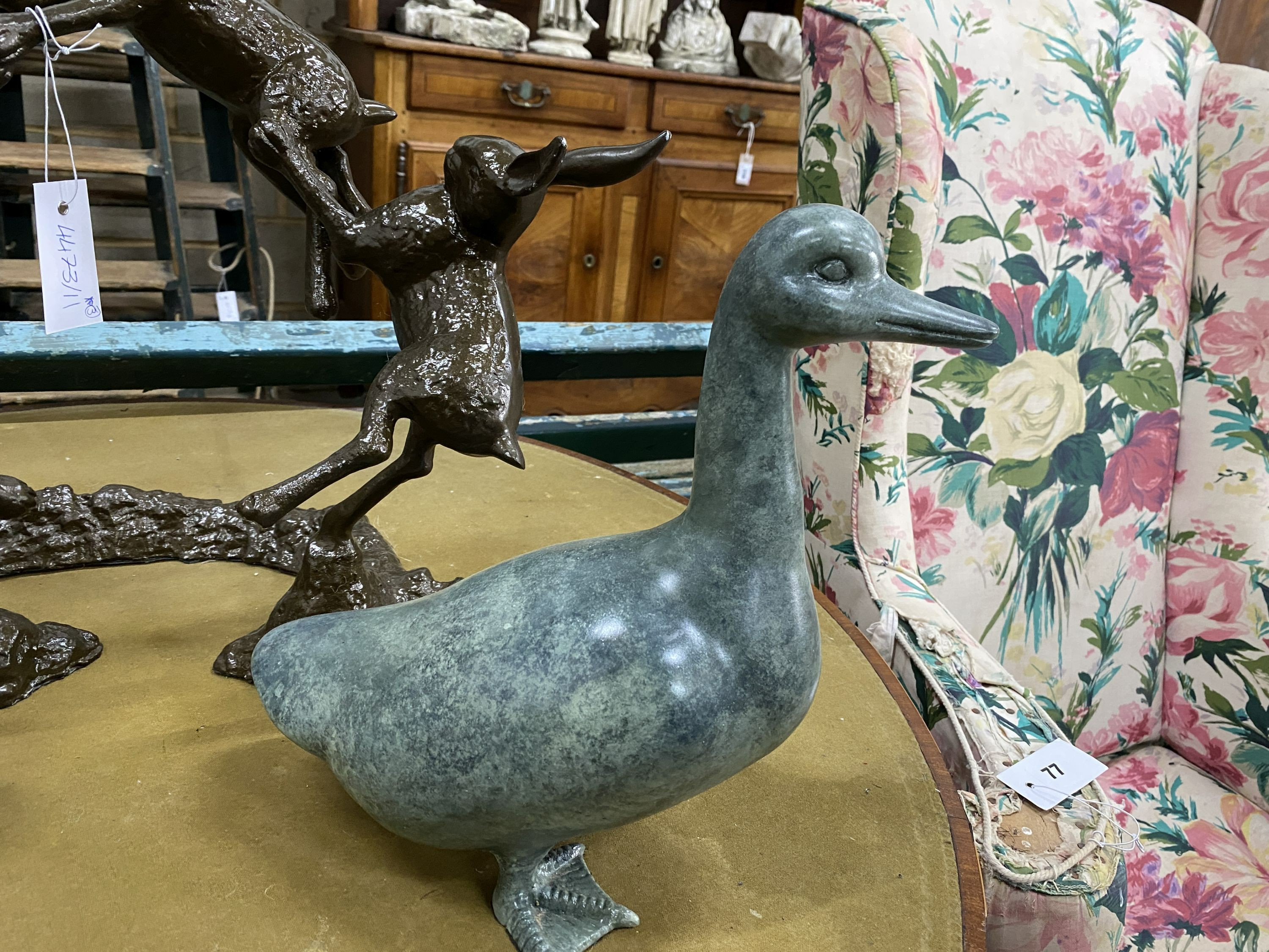 A simulated bronze hare garden ornament, height 46cm, together with two faux bronze models of ducks